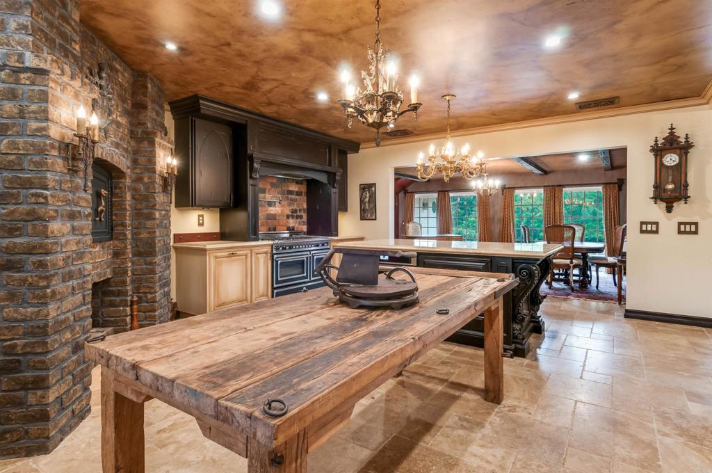725 Hamilton Lane Fallbrook, CA 92028 - Photo 30 of 54 a kitchen with a stove a counter space a sink and chandelier