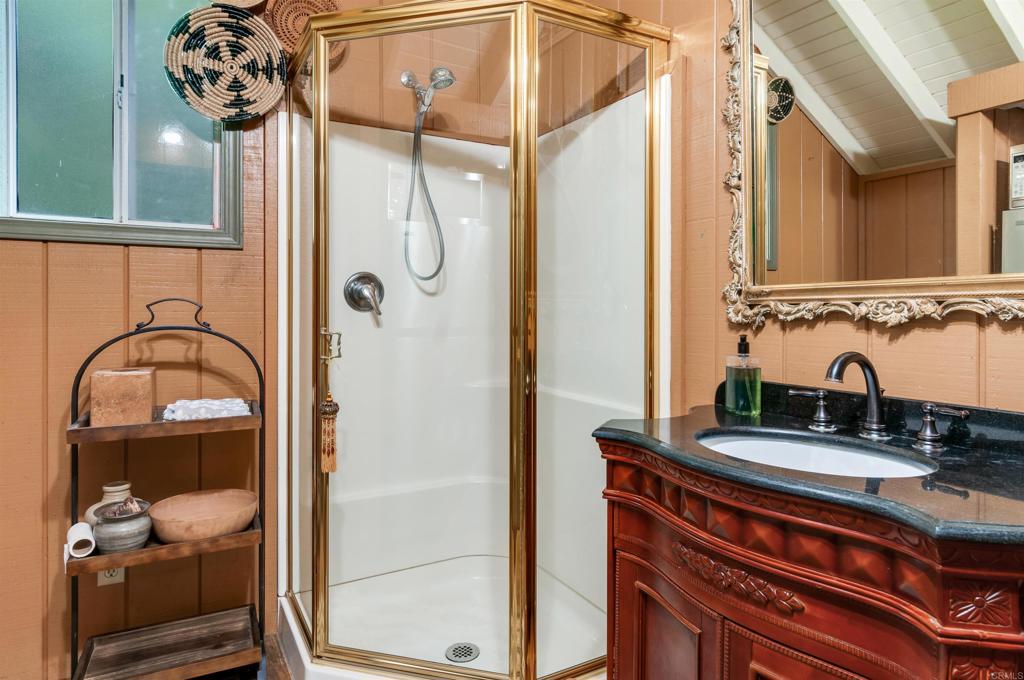 725 Hamilton Lane Fallbrook, CA 92028 - Photo 53 of 54 a bathroom with a sink a mirror and shower