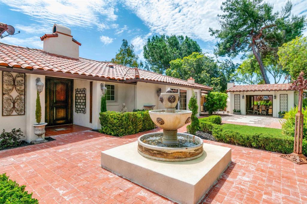 725 Hamilton Lane Fallbrook, CA 92028 - Photo 7 of 54 a front view of a house with a garden and patio