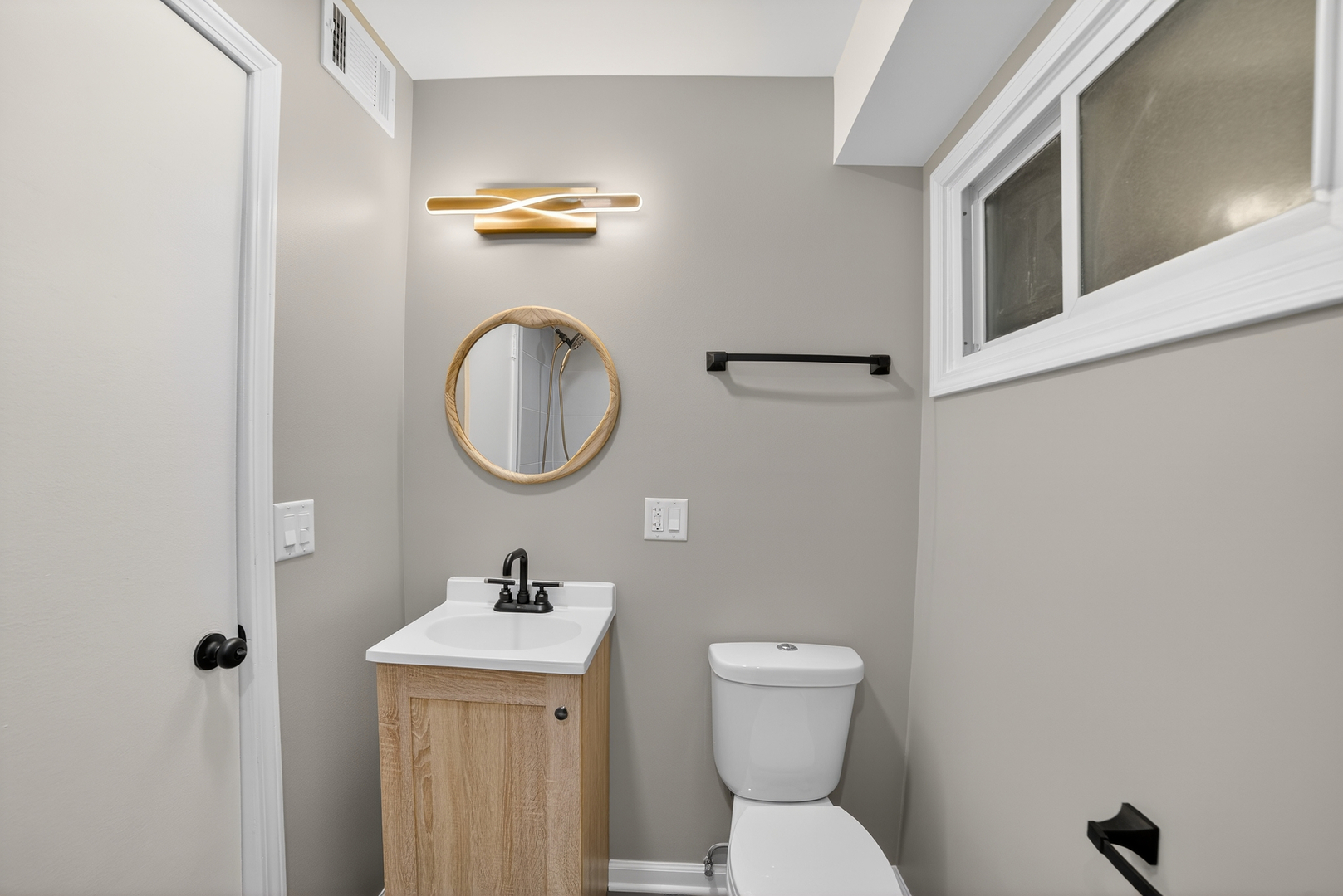 525 North Springfield Avenue Chicago, IL 60624 - Photo 16 of 24 a bathroom with a toilet a sink and a mirror