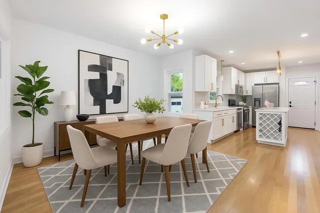 a view of a dining room with furniture and wooden floor