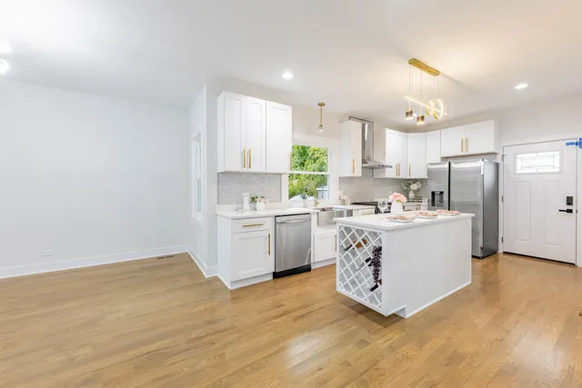 a kitchen with a refrigerator a sink and cabinets