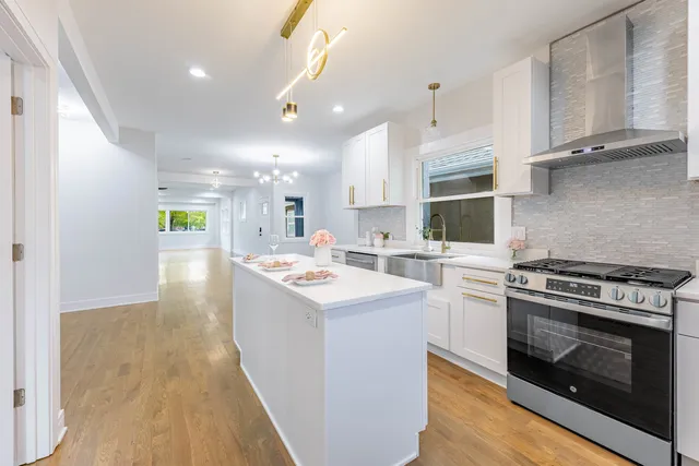 a kitchen with stove and cabinets