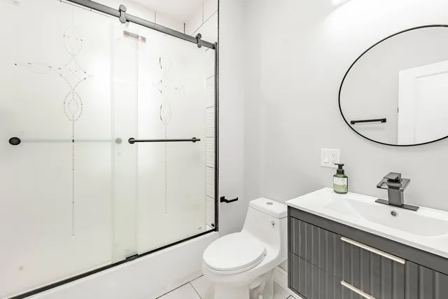 a bathroom with a sink a toilet and a mirror