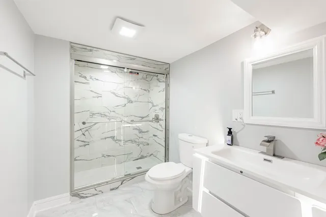 a bathroom with a sink toilet and shower