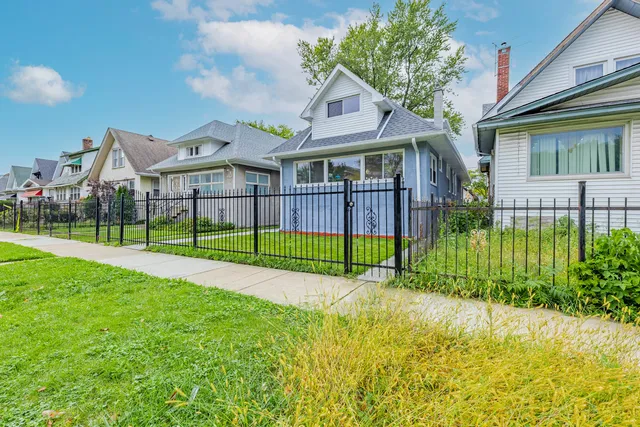 a view of a house with a big yard and potted plants