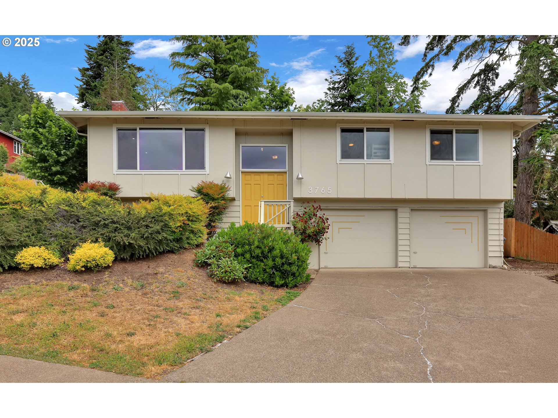 a front view of a house with a yard and potted plants