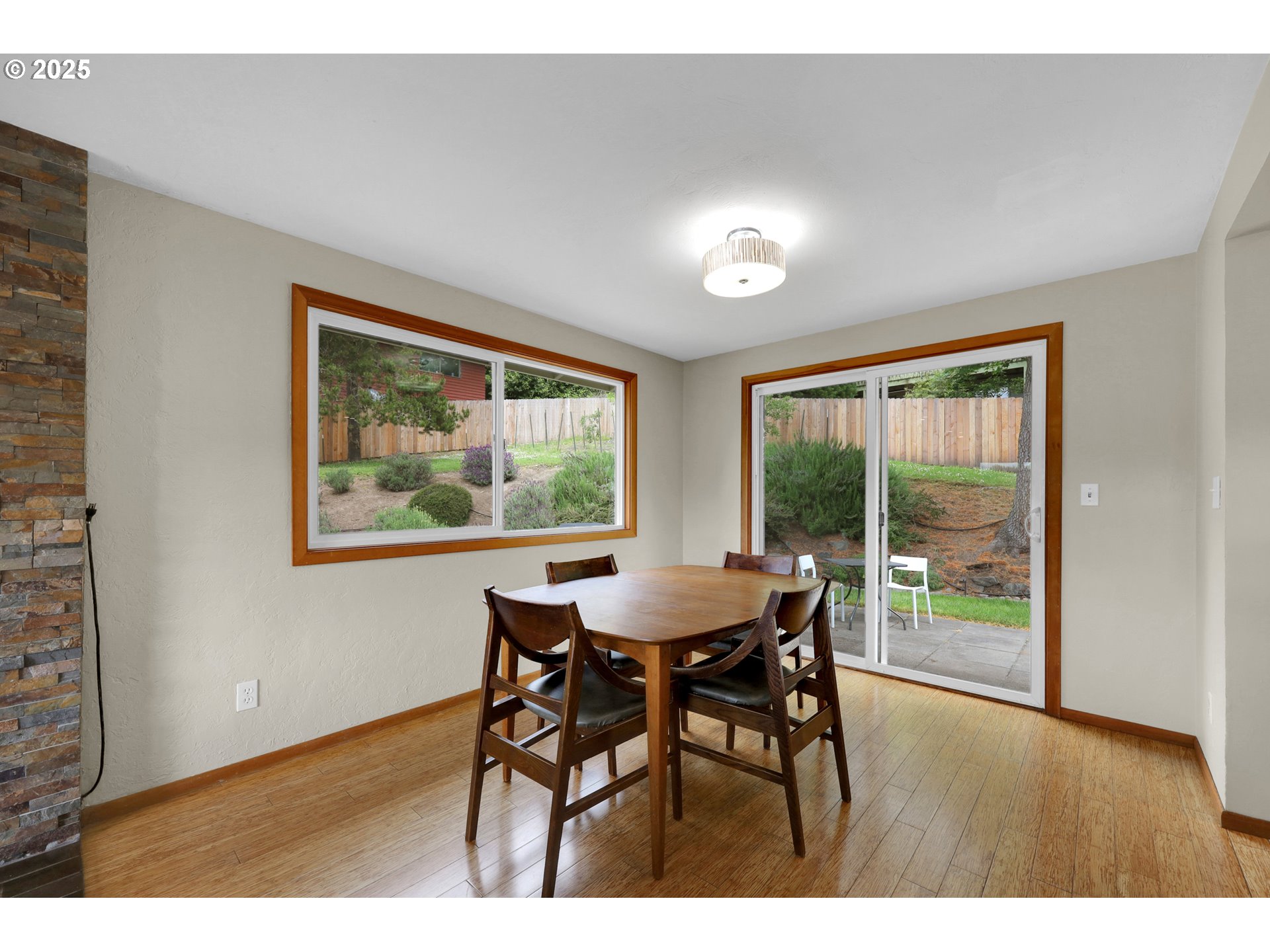 3765 Potter Street Eugene, OR 97405 - Photo 11 of 48 a view of a dining room with furniture large windows and wooden floor