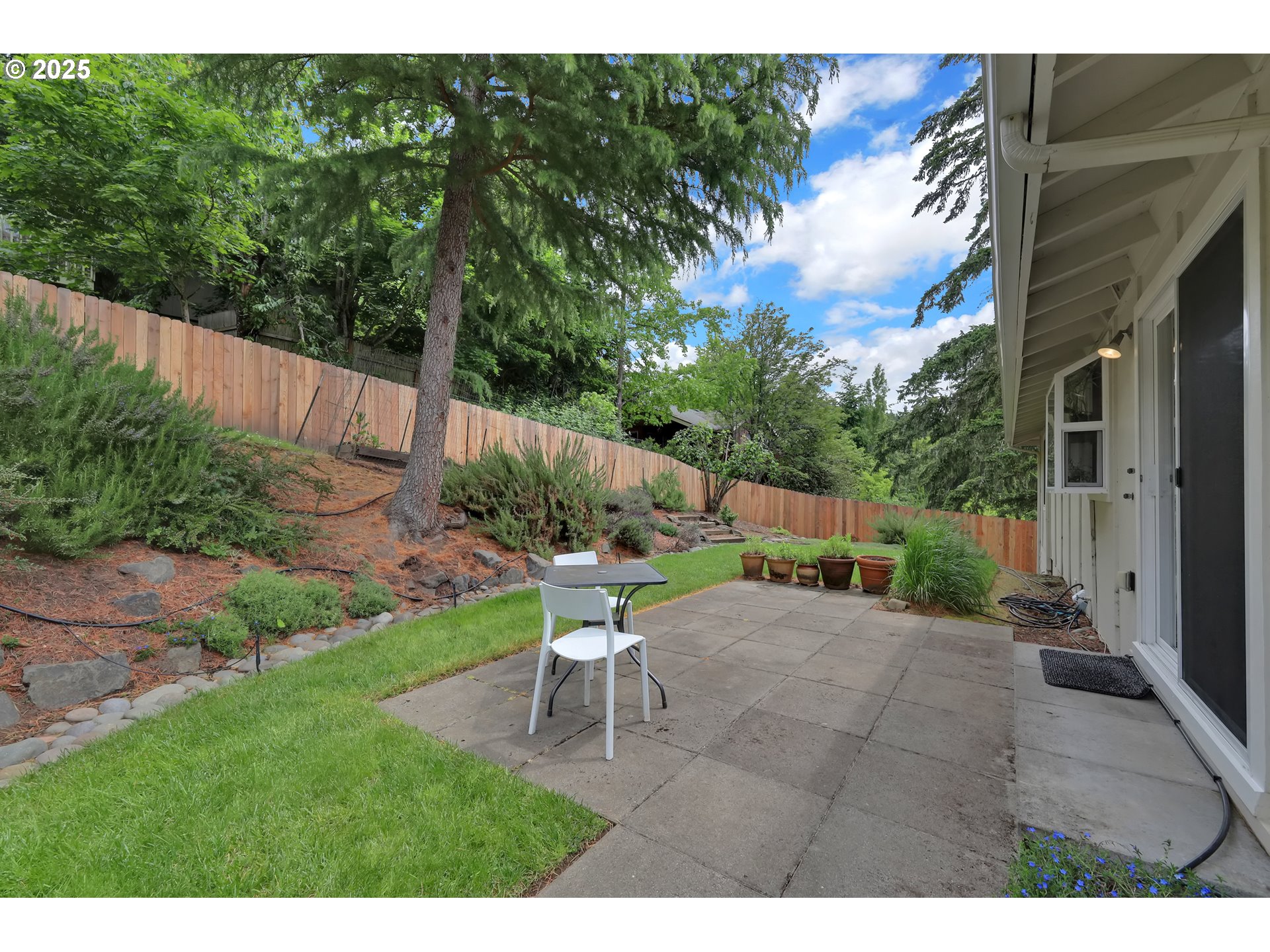 3765 Potter Street Eugene, OR 97405 - Photo 37 of 48 a view of a patio with table and chairs with wooden fence