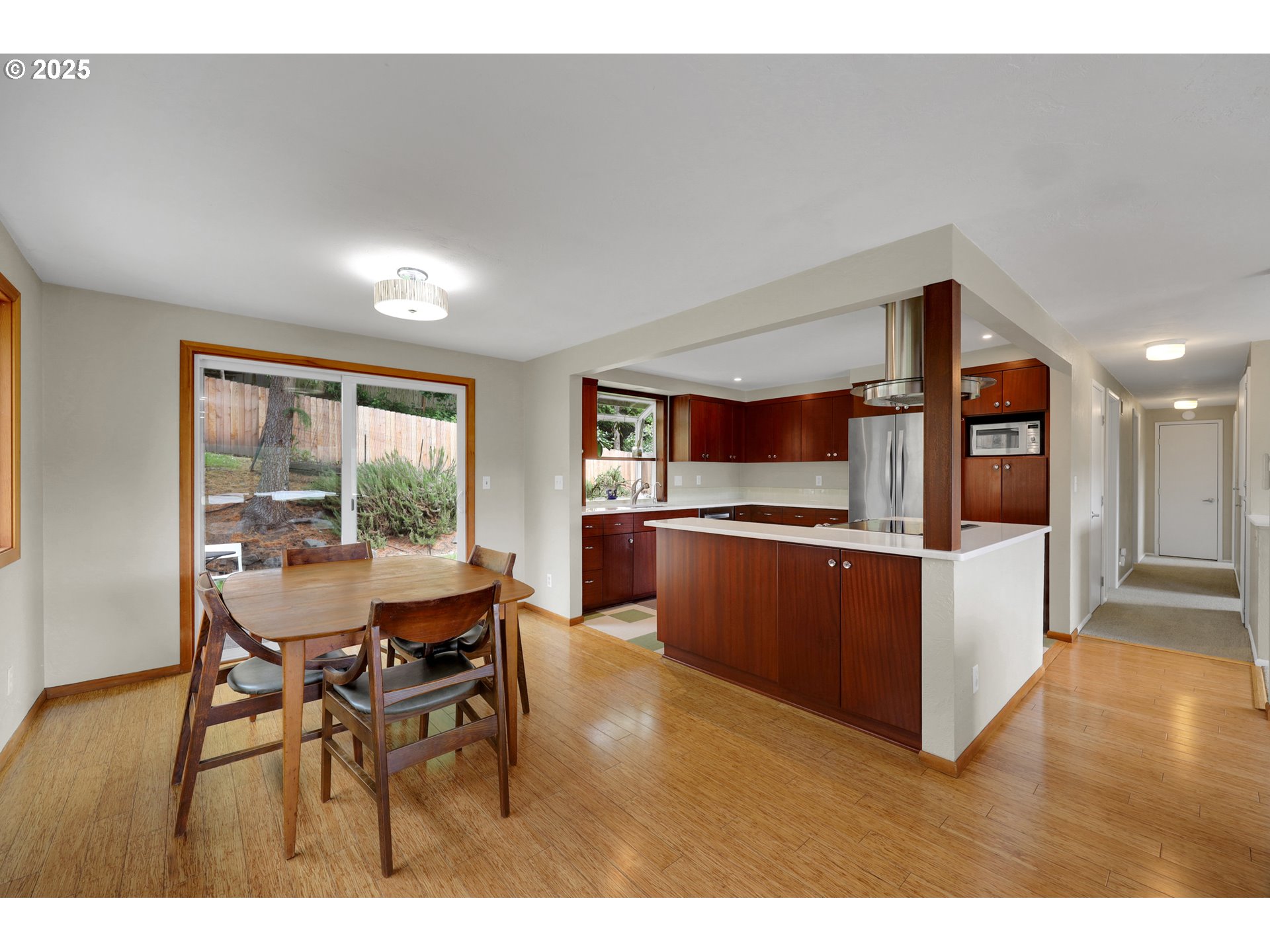 3765 Potter Street Eugene, OR 97405 - Photo 5 of 48 a kitchen with stainless steel appliances kitchen island granite countertop a table and chairs