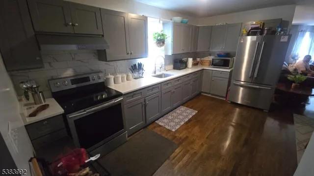 a kitchen with a sink appliances and cabinets