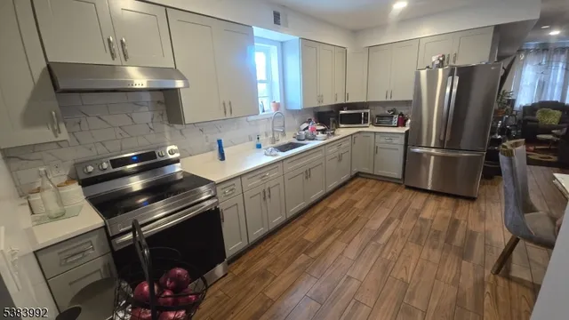 a kitchen with a sink appliances and cabinets