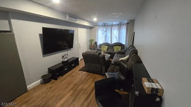a view of a livingroom with furniture and a flat screen tv