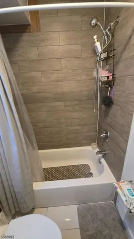 a bathroom with a bathtub and shower