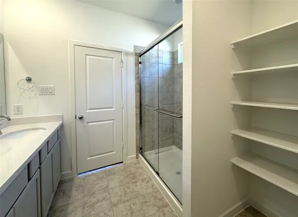 a bathroom with a shower and a sink