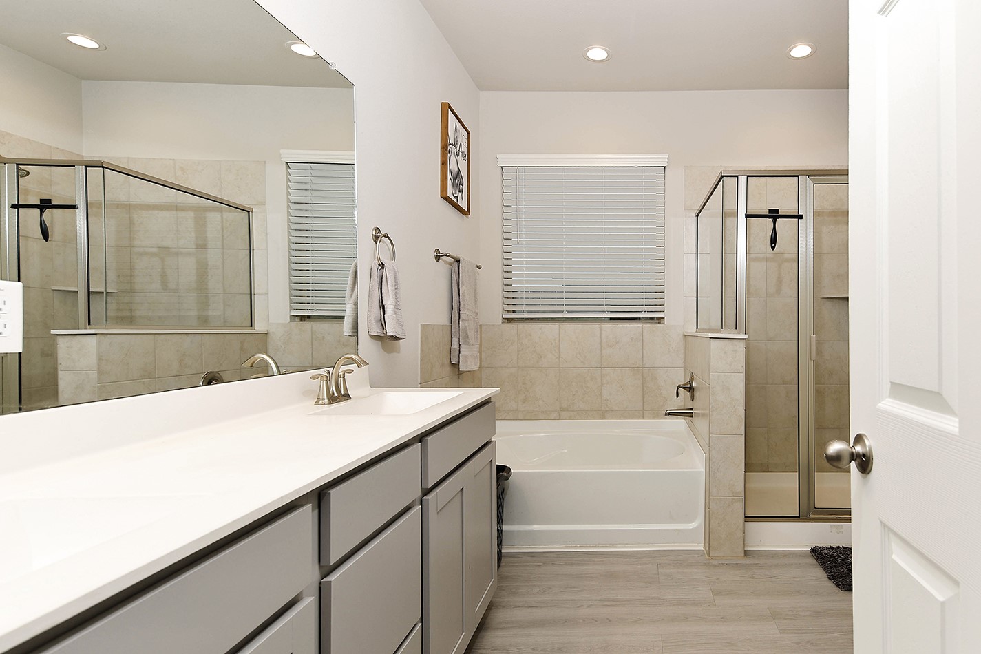 26324 Cooperstown Way Splendora, TX 77372 - Photo 14 of 23 a bathroom with a tub sink and mirror