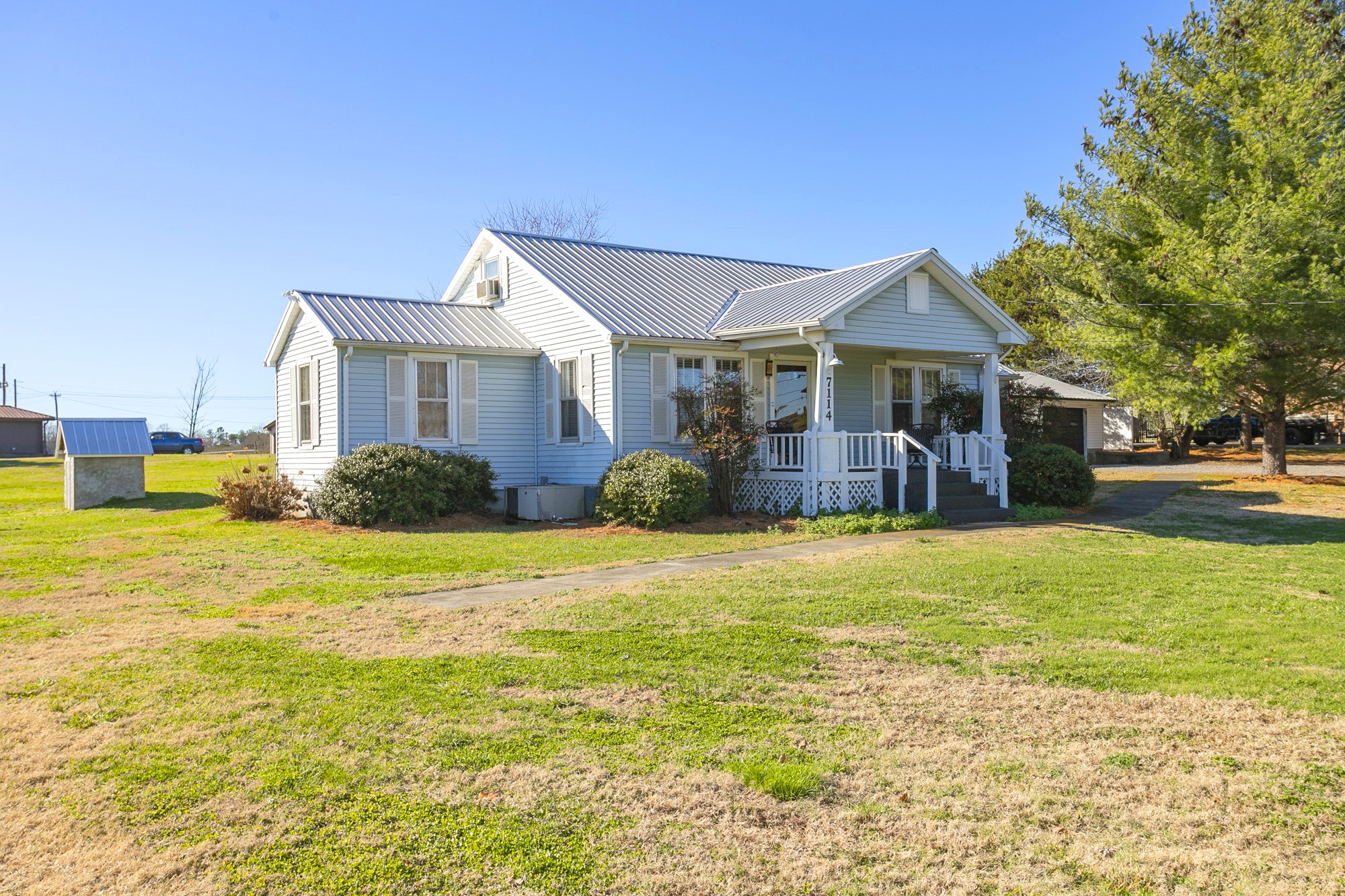 7114 Deer Ridge Road Fairview, TN 37062 - Photo 5 of 55 a front view of a house with a garden and yard