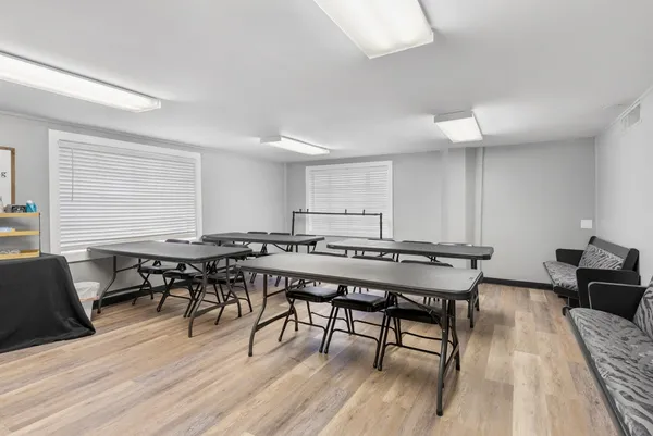 a view of a a dining room with furniture window and wooden floor