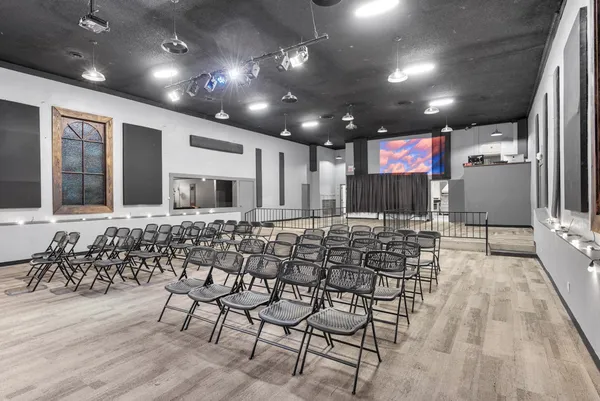 a very nice looking room with a chair and tables