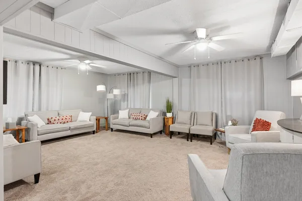 a living room with furniture and a chandelier