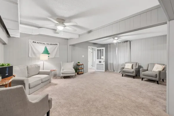a living room with furniture and a chandelier