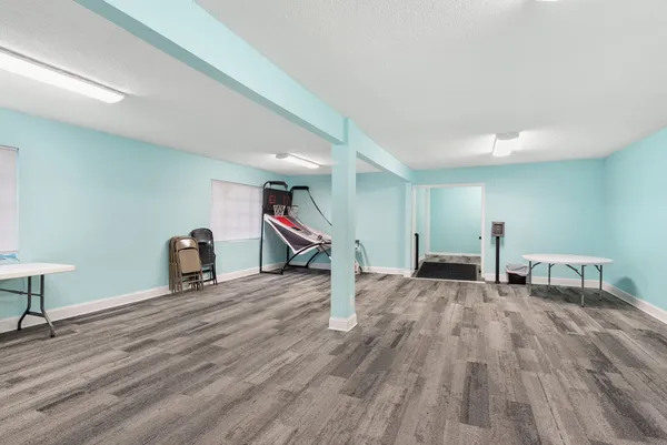 a view of a room with wooden floor