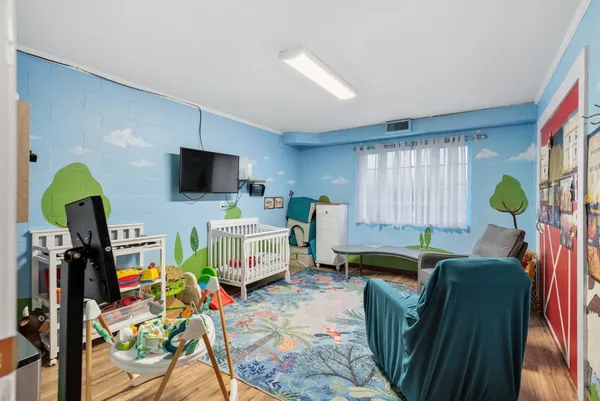 a living room with furniture a window and a flat screen tv