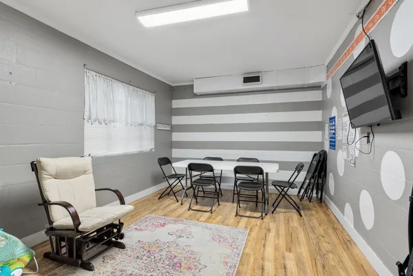 a dining room with furniture and wooden floor