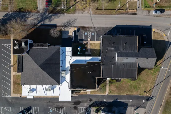 an aerial view of a house with a yard