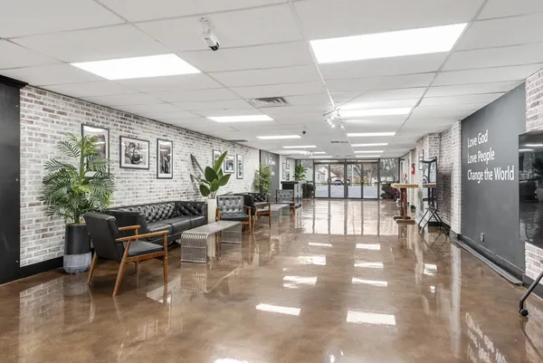 a room with lots of furniture and a large window