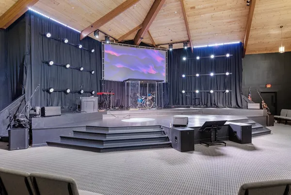 a room with pool table and chairs