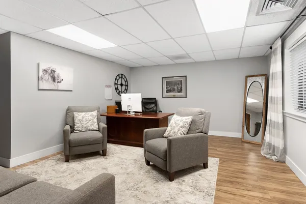 a living room with furniture and a wooden floor