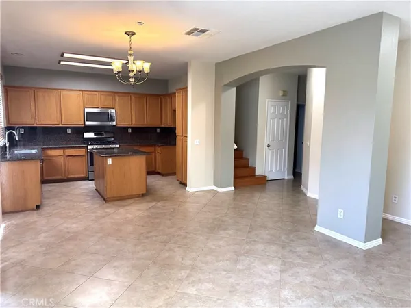 a view of a kitchen with a sink and a refrigerator