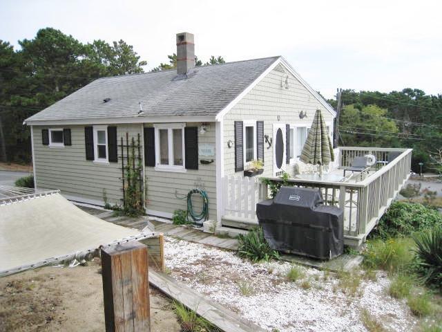 130 Pleasant Point Road Wellfleet, MA 02667 - Photo 2 of 20 a front view of a house with garden