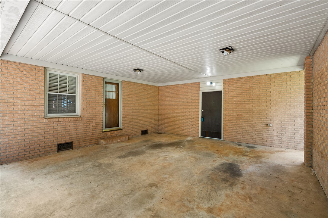 2101 Old Spring Drive Anderson, SC 29625 - Photo 21 of 36 A well-lit covered outdoor space with brick walls provides a versatile area for parking or recreation.