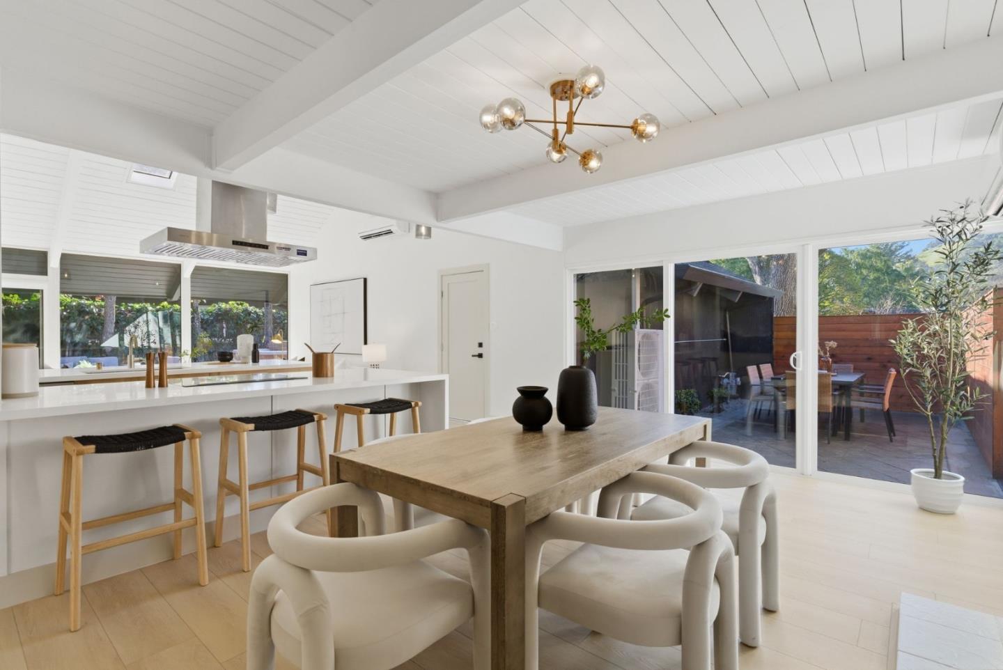 2212 Juniperberry Drive San Rafael, CA 94903 - Photo 23 of 81 a dining room with wooden floor a chandelier fan a wooden table and chairs