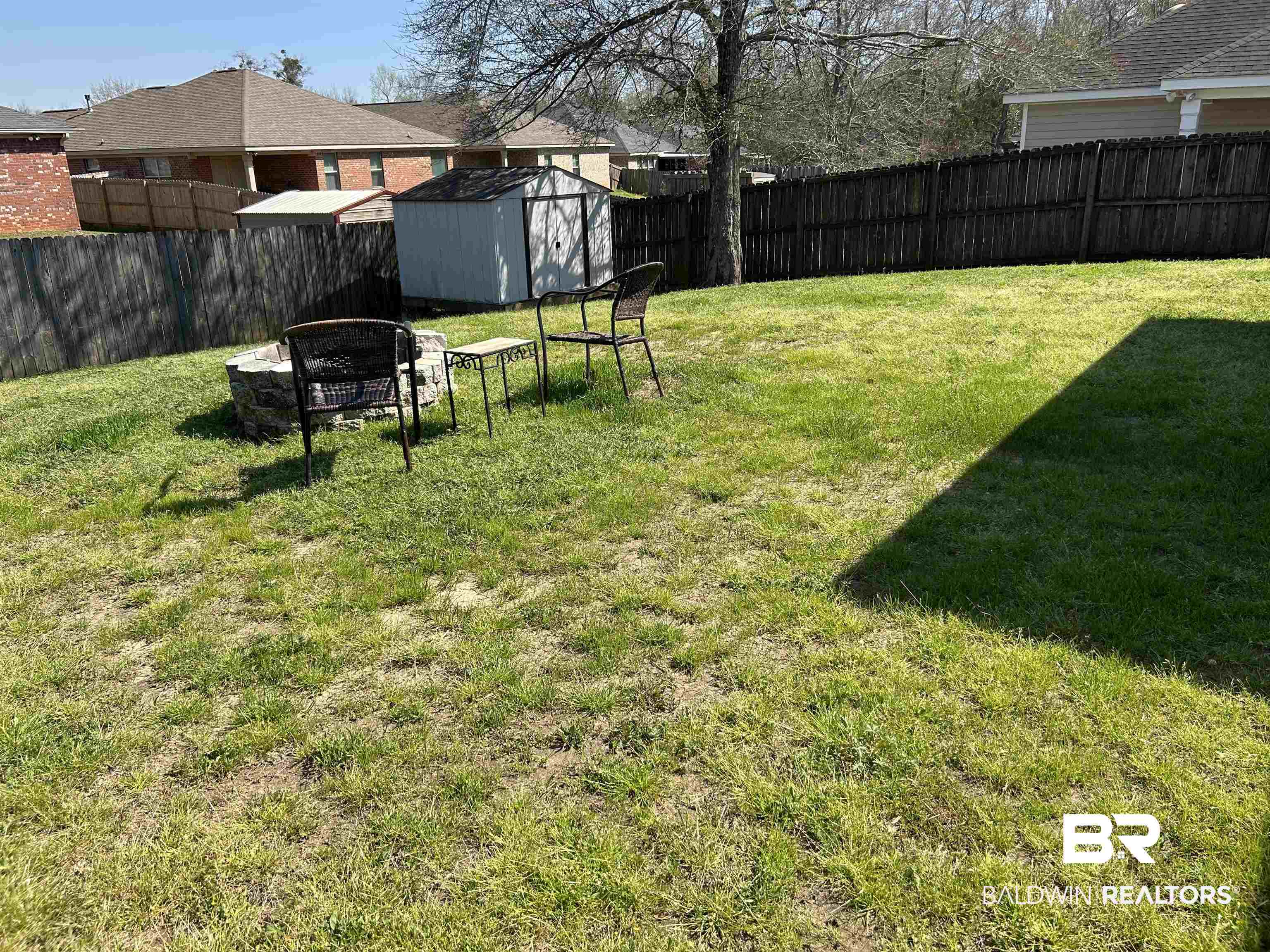 919 Parliament Court Mobile, AL 36695 - Photo 18 of 19 View of yard featuring a shed, an outdoor structure, and a fenced backyard