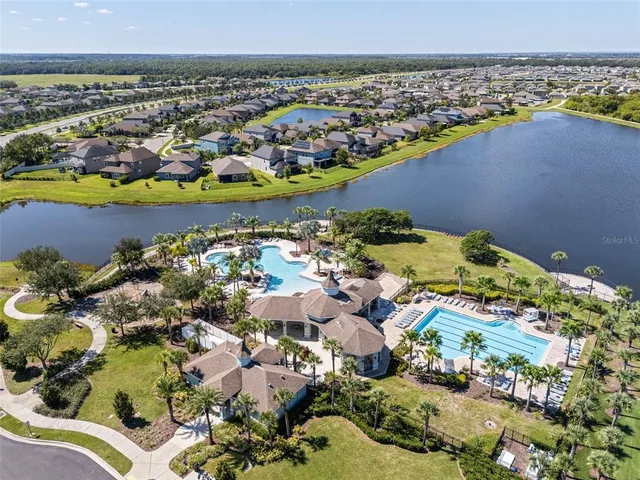 an aerial view of a houses with a lake view