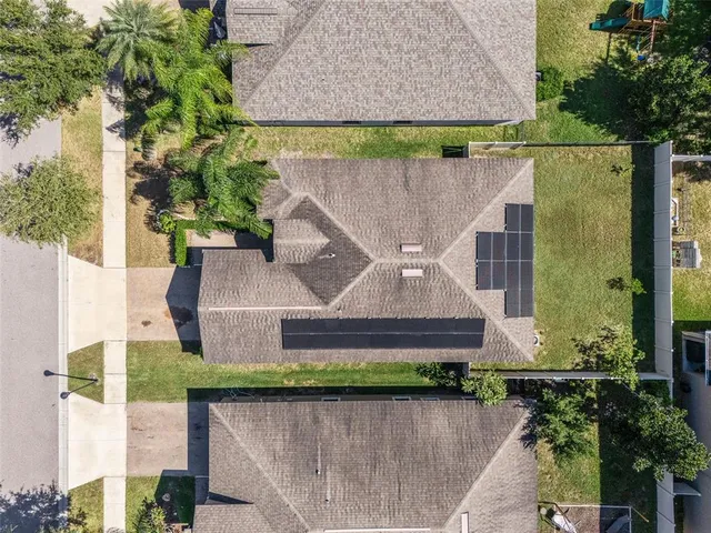 an aerial view of a house with a yard