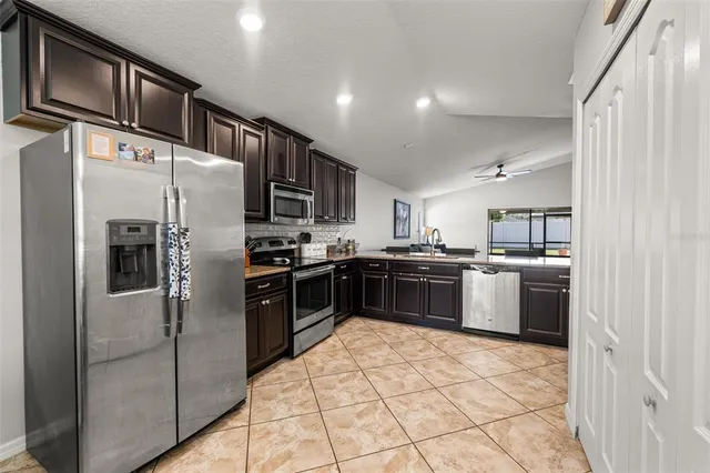 a kitchen with stainless steel appliances and refrigerator