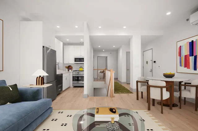 a living room with furniture and a dining table with kitchen view