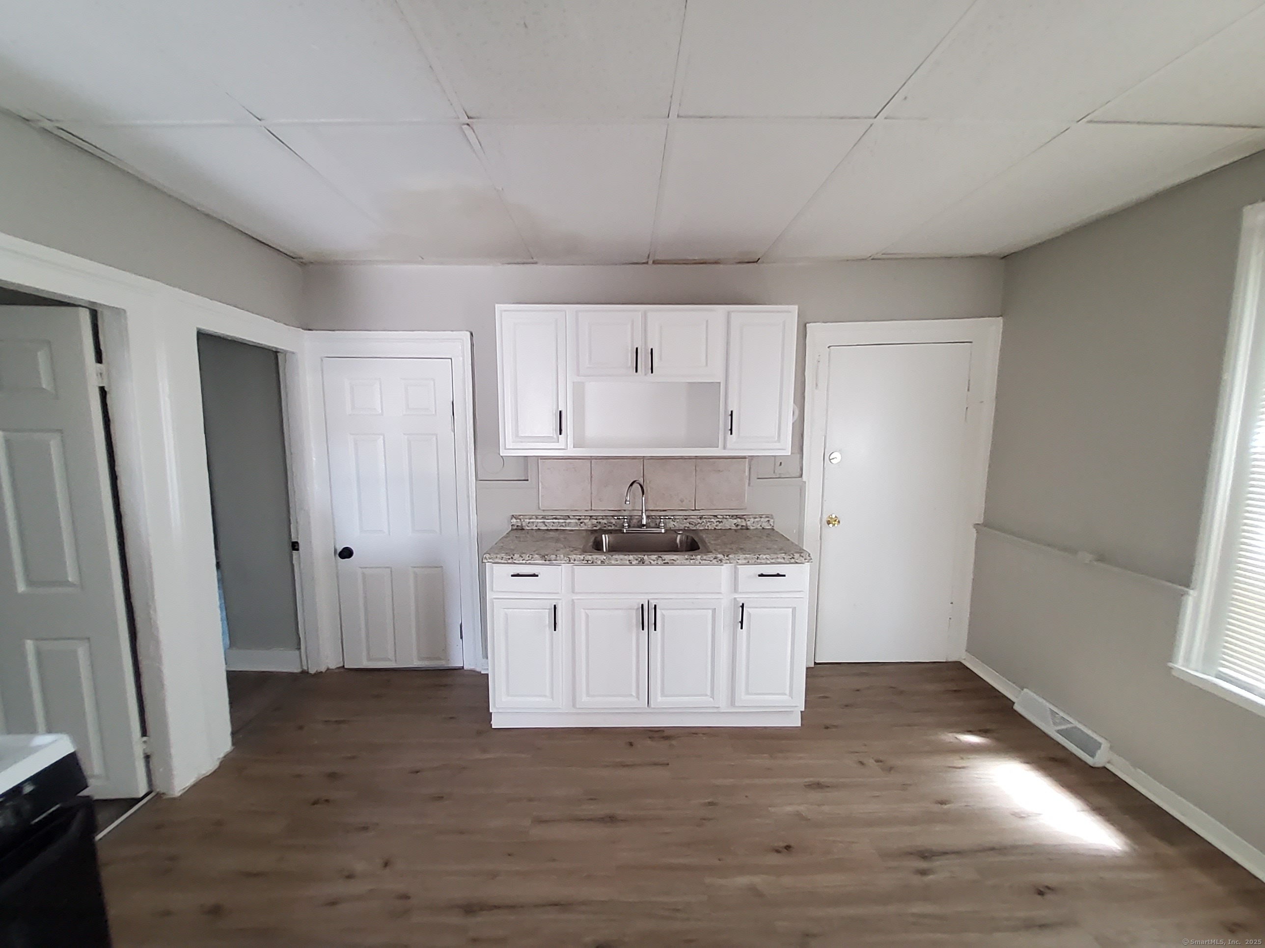 199 Saltonstall Avenue, Unit 1 New Haven, CT 06513 - Photo 11 of 12 a kitchen with granite countertop a sink and a stove top oven