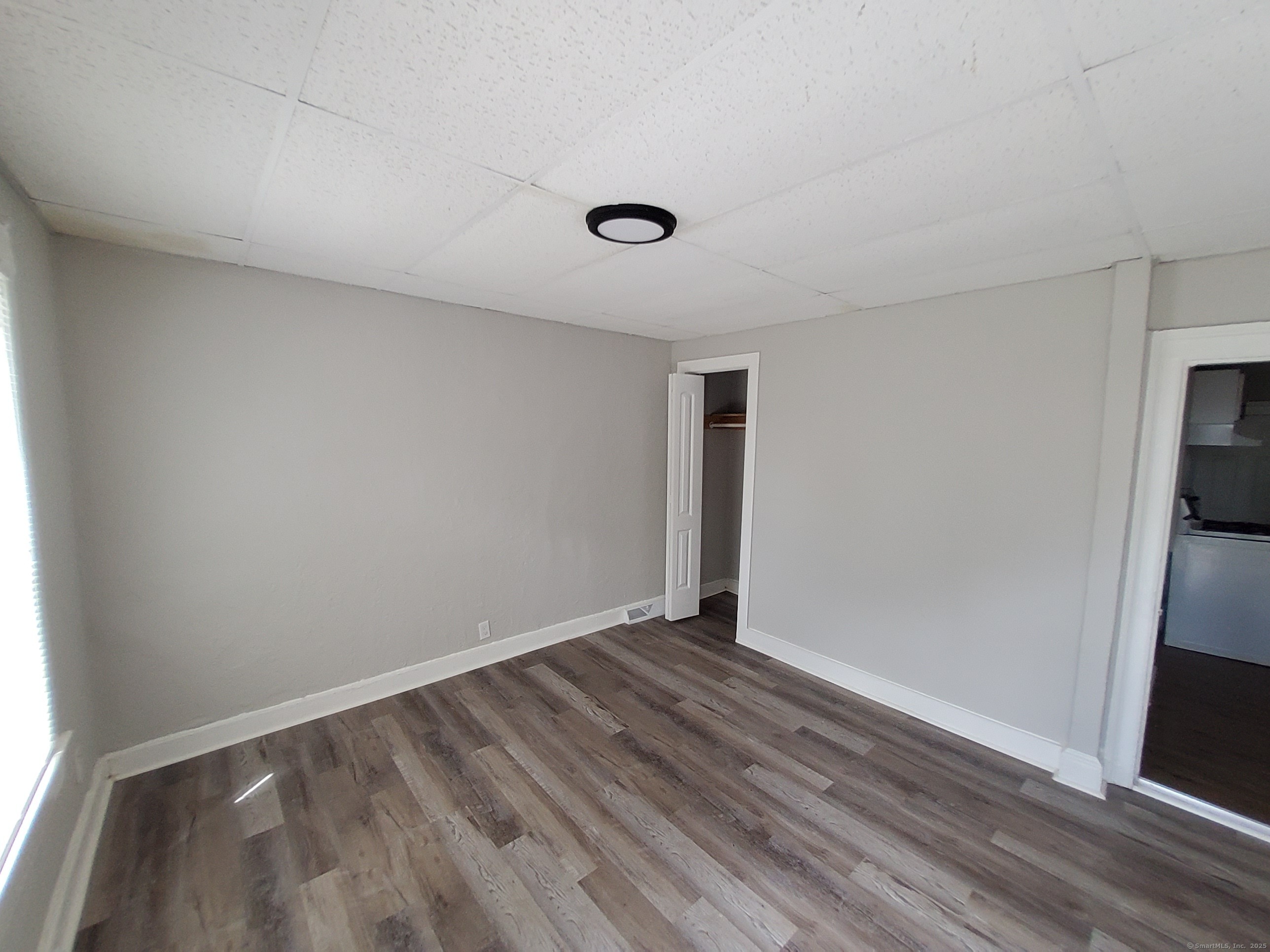 199 Saltonstall Avenue, Unit 1 New Haven, CT 06513 - Photo 3 of 12 a view of an empty room with wooden floor and a window
