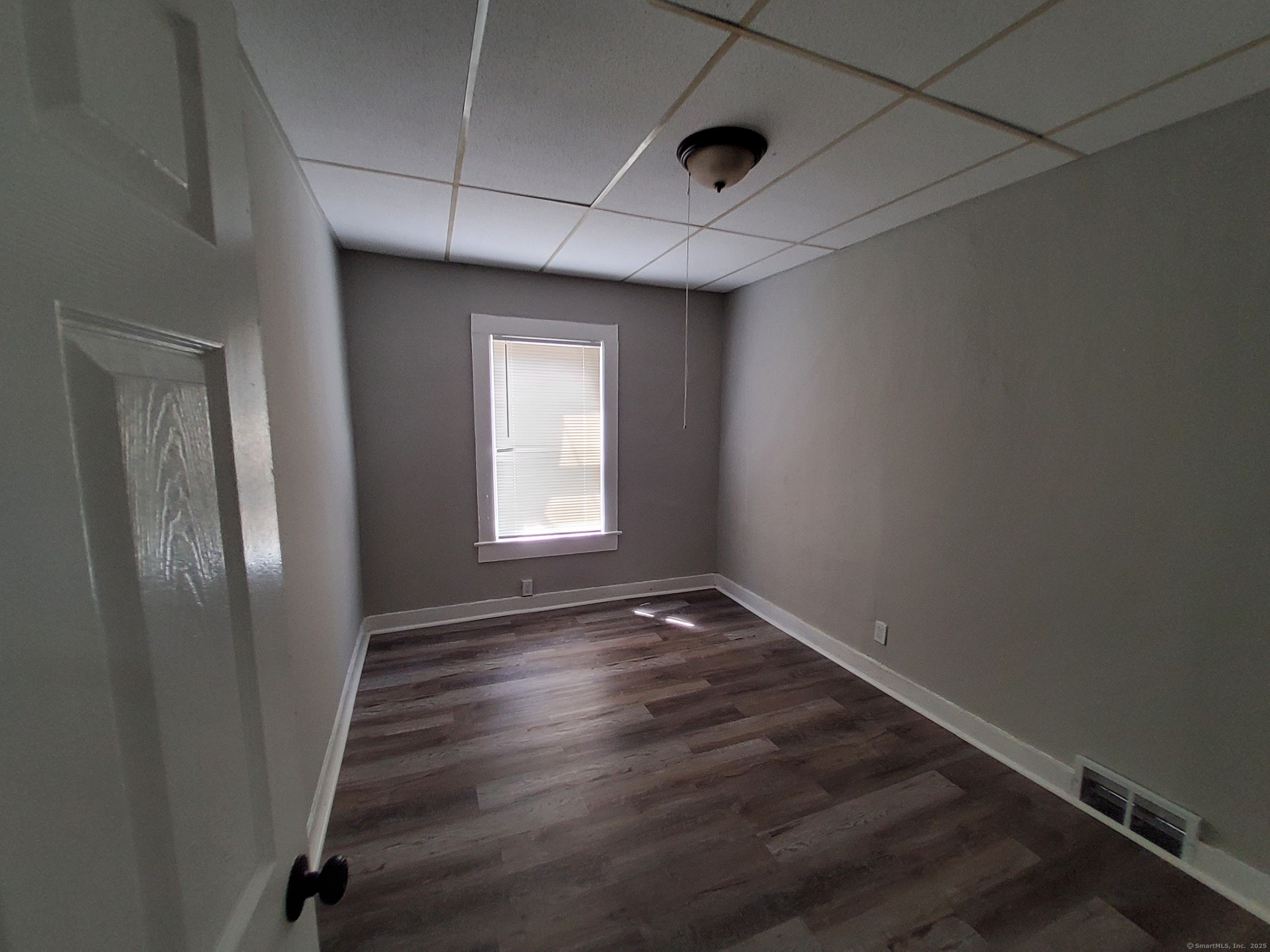 199 Saltonstall Avenue, Unit 1 New Haven, CT 06513 - Photo 5 of 12 an empty room with wooden floor and windows