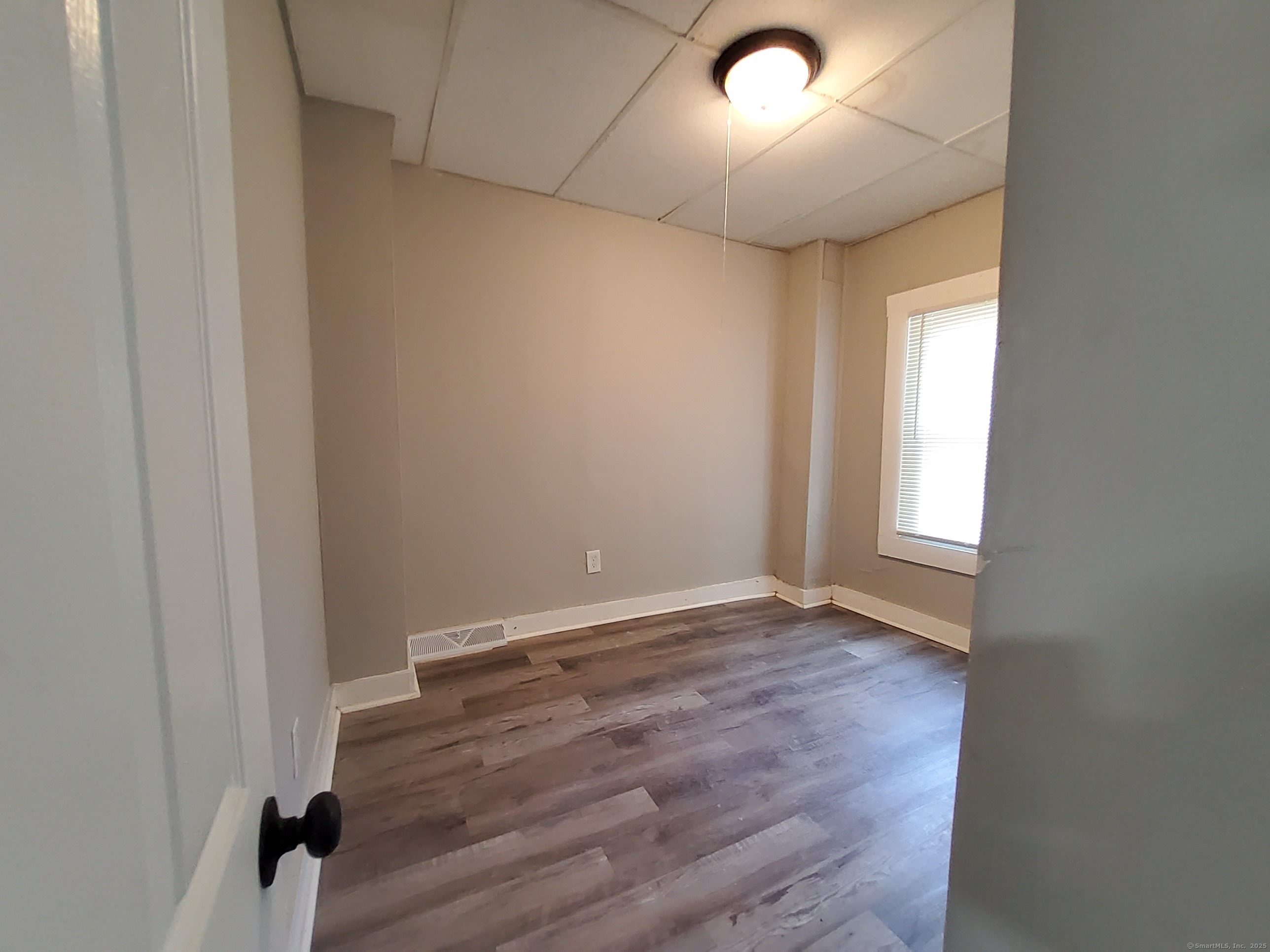199 Saltonstall Avenue, Unit 1 New Haven, CT 06513 - Photo 7 of 12 an empty room with wooden floor and windows