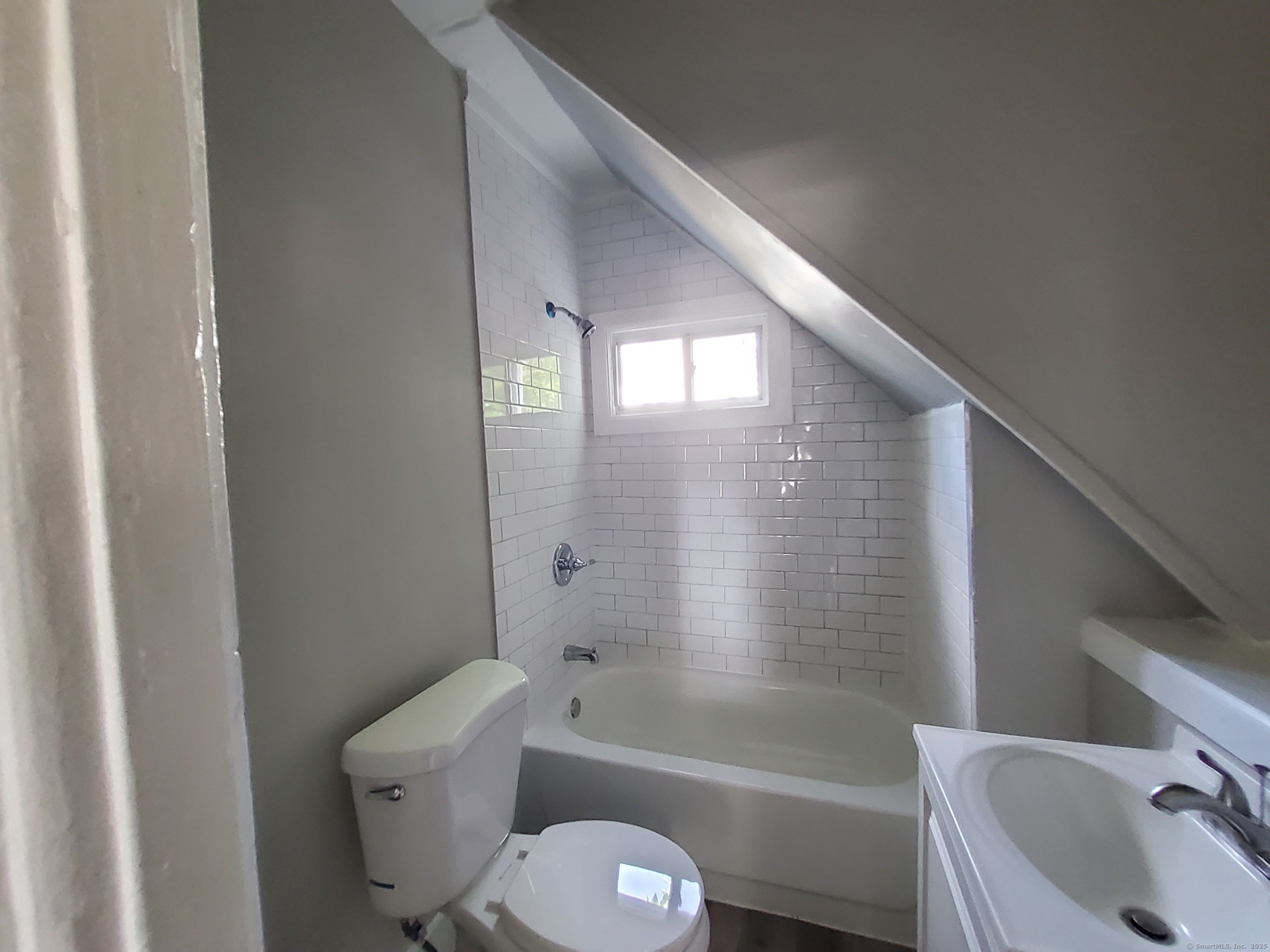 199 Saltonstall Avenue, Unit 1 New Haven, CT 06513 - Photo 8 of 12 a bathroom with a granite countertop toilet a sink and bathtub