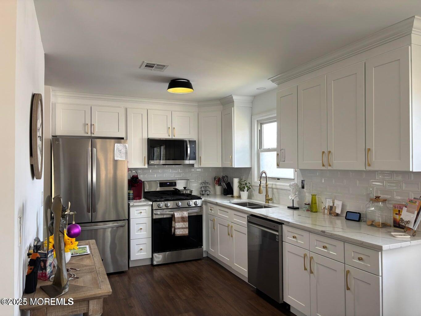 10 Whitman Street Brick, NJ 08724 - Photo 5 of 19 a kitchen with a sink stainless steel appliances and cabinets