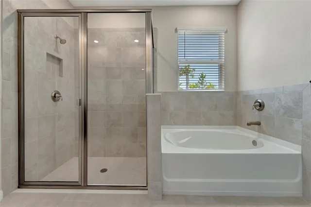 a white bath tub sitting next to a shower