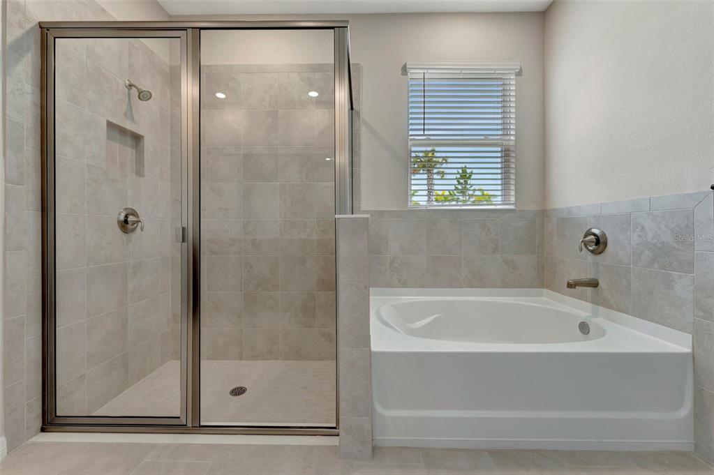 5210 Grove Mill Loop Lakewood Ranch, FL 34211 - Photo 23 of 48 a white bath tub sitting next to a shower