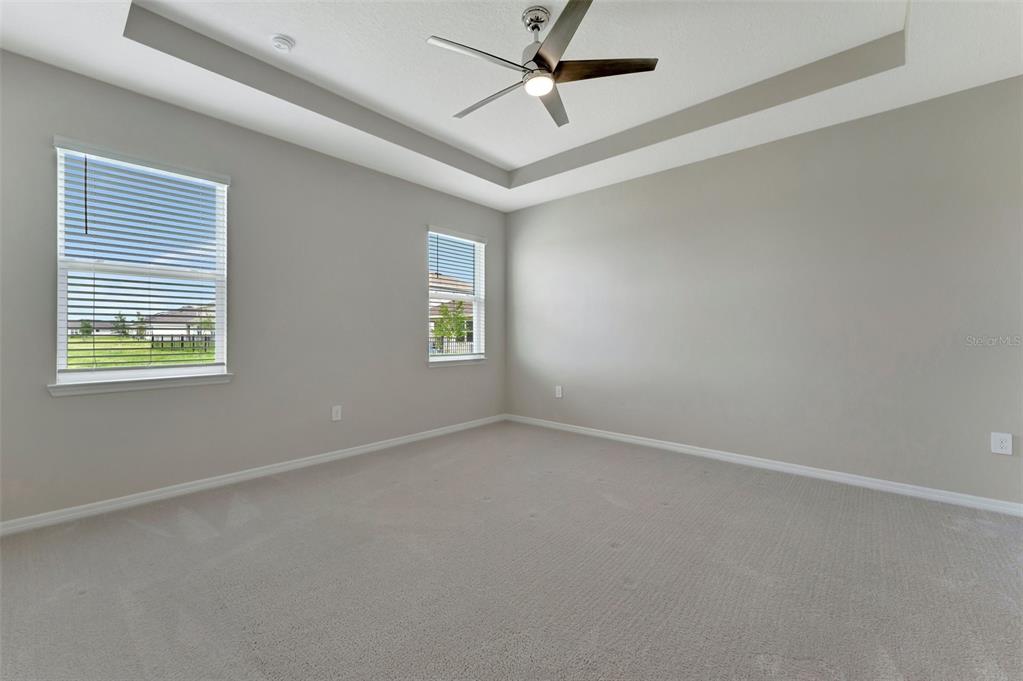 5210 Grove Mill Loop Lakewood Ranch, FL 34211 - Photo 25 of 48 an empty room with a window and a fan